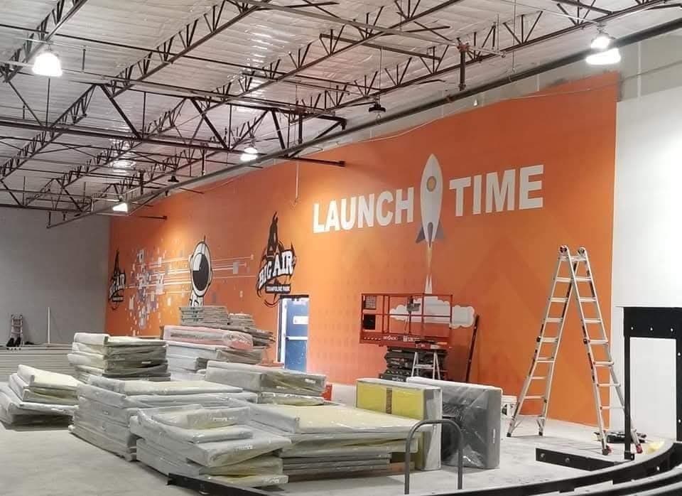 Large commercial wall mural installation at Big Air trampoline park in Arizona